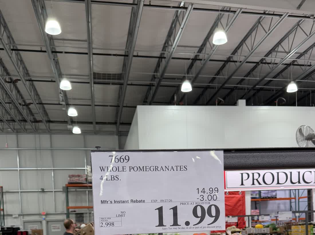 Costco shelf tag: whole pomegranates, 4 lb, $14.99 less a $3.00 manufacturer's instant rebate, $11.99 at the register