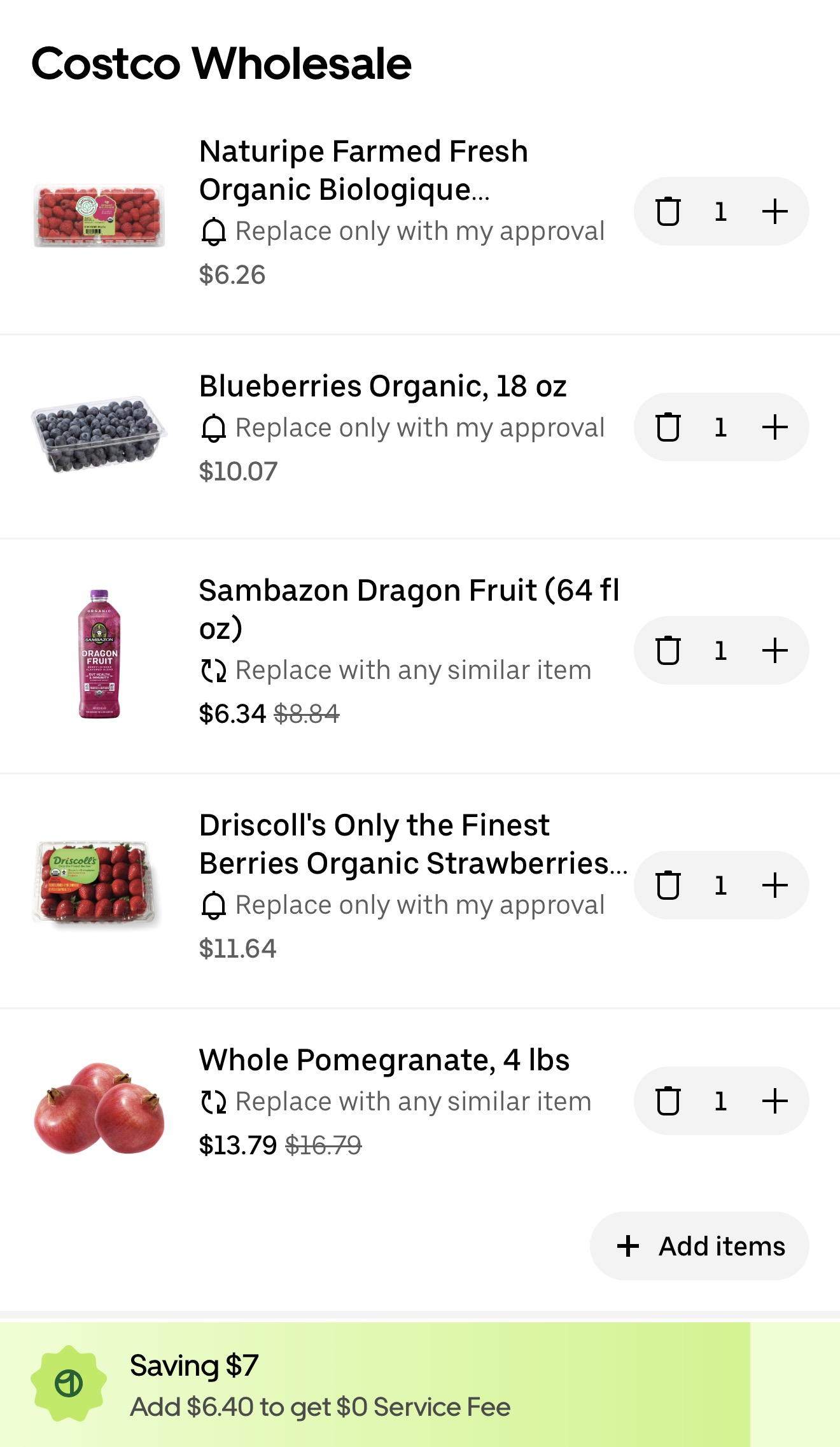 Uber Eats cart for the same five Costco items: organic raspberries $6.26, organic blueberries $10.07, Sambazon dragon fruit $6.34 was $8.84, organic strawberries $11.64, whole pomegranate $13.79 was $16.79, with an Uber One badge reading Saving $7 and a prompt to add $6.40 for a $0 service fee