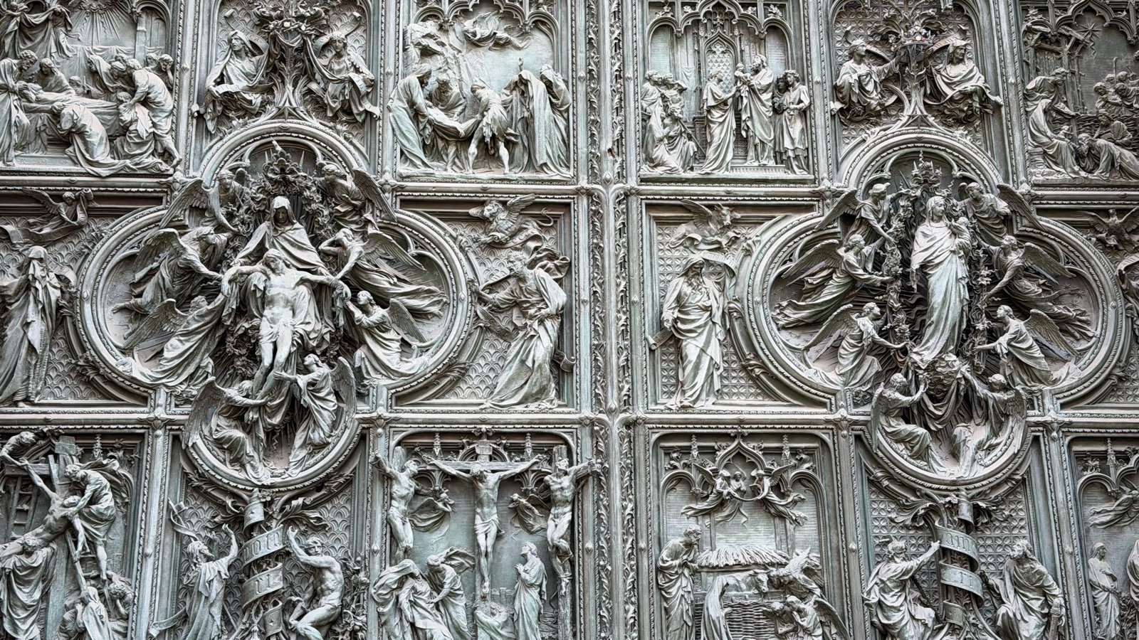 Close-up of the Duomo's bronze door panels, covered in relief figures