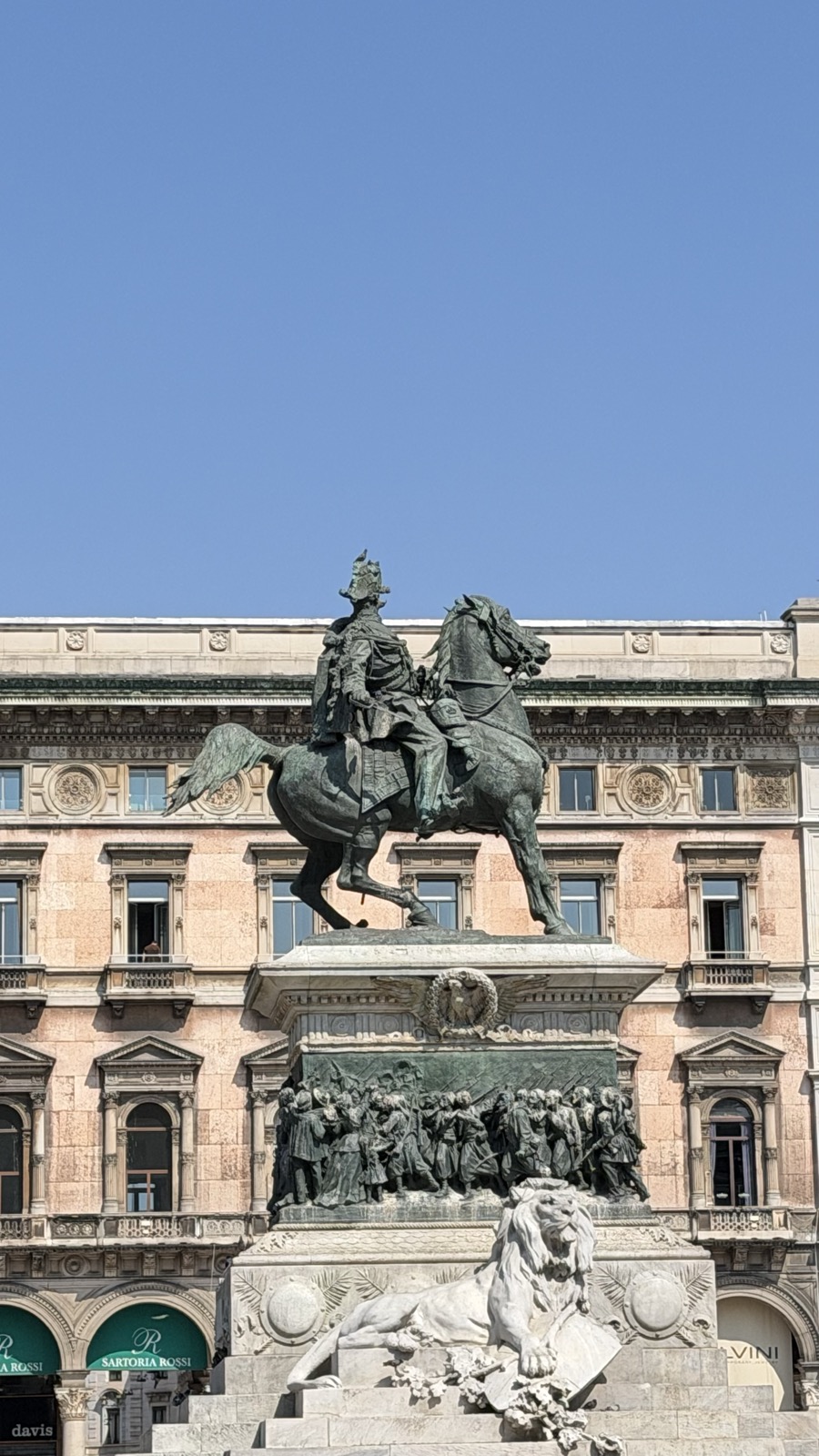 The equestrian statue of Vittorio Emanuele II on its pedestal in front of an ornate arcaded building
