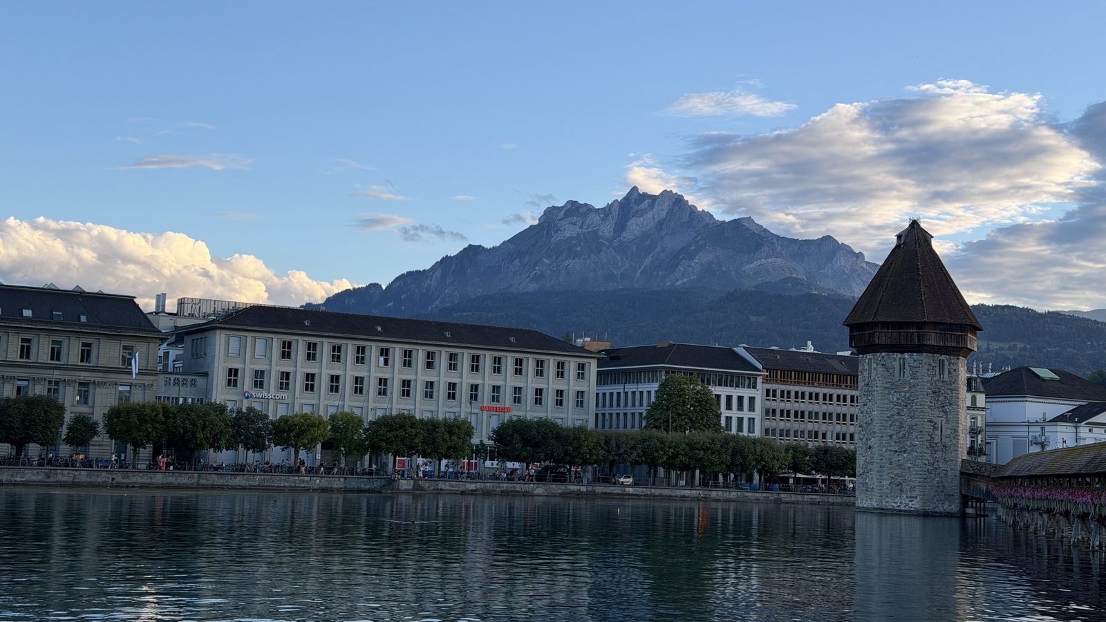 The Chapel Bridge and the Water Tower over the Reuss in evening light, with Mount Pilatus behind